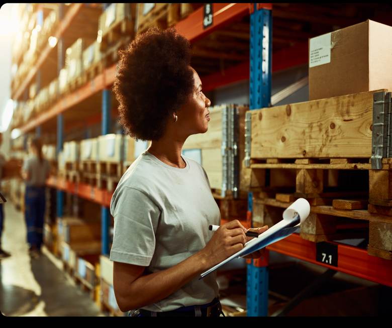 A records officer cataloguing boxes in a storage facility